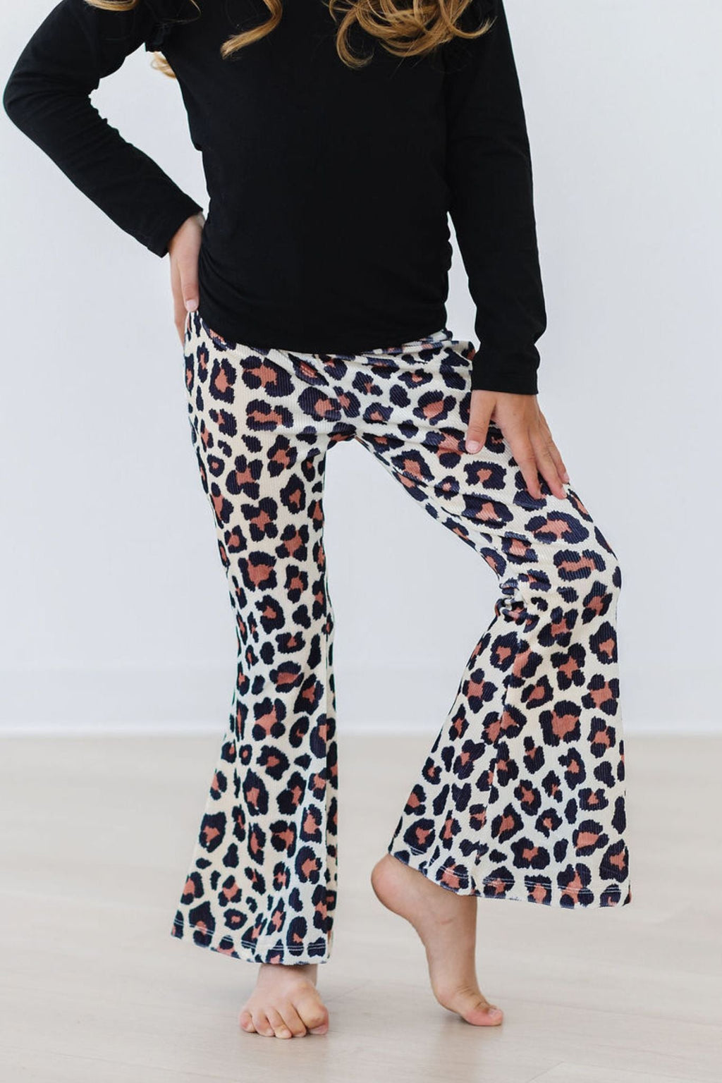 Young girl modeling comfortable leopard print ribbed velvet flare pants