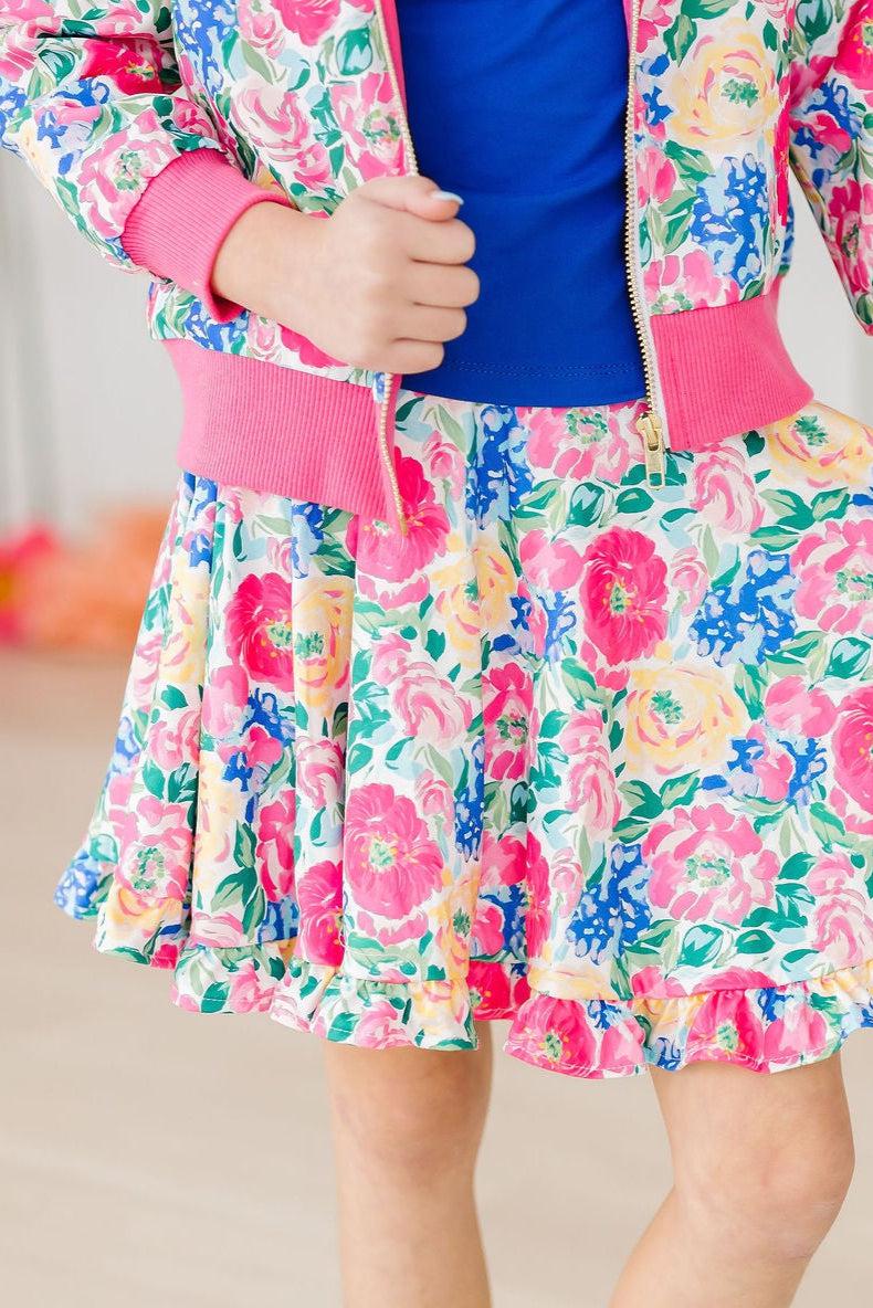 Young girl wearing a floral Wildflower Wishes ruffle twirl skort with attached shorts