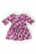 Baby wearing a bright pink long-sleeve twirl bodysuit with a cute white ghost and witch hat pattern