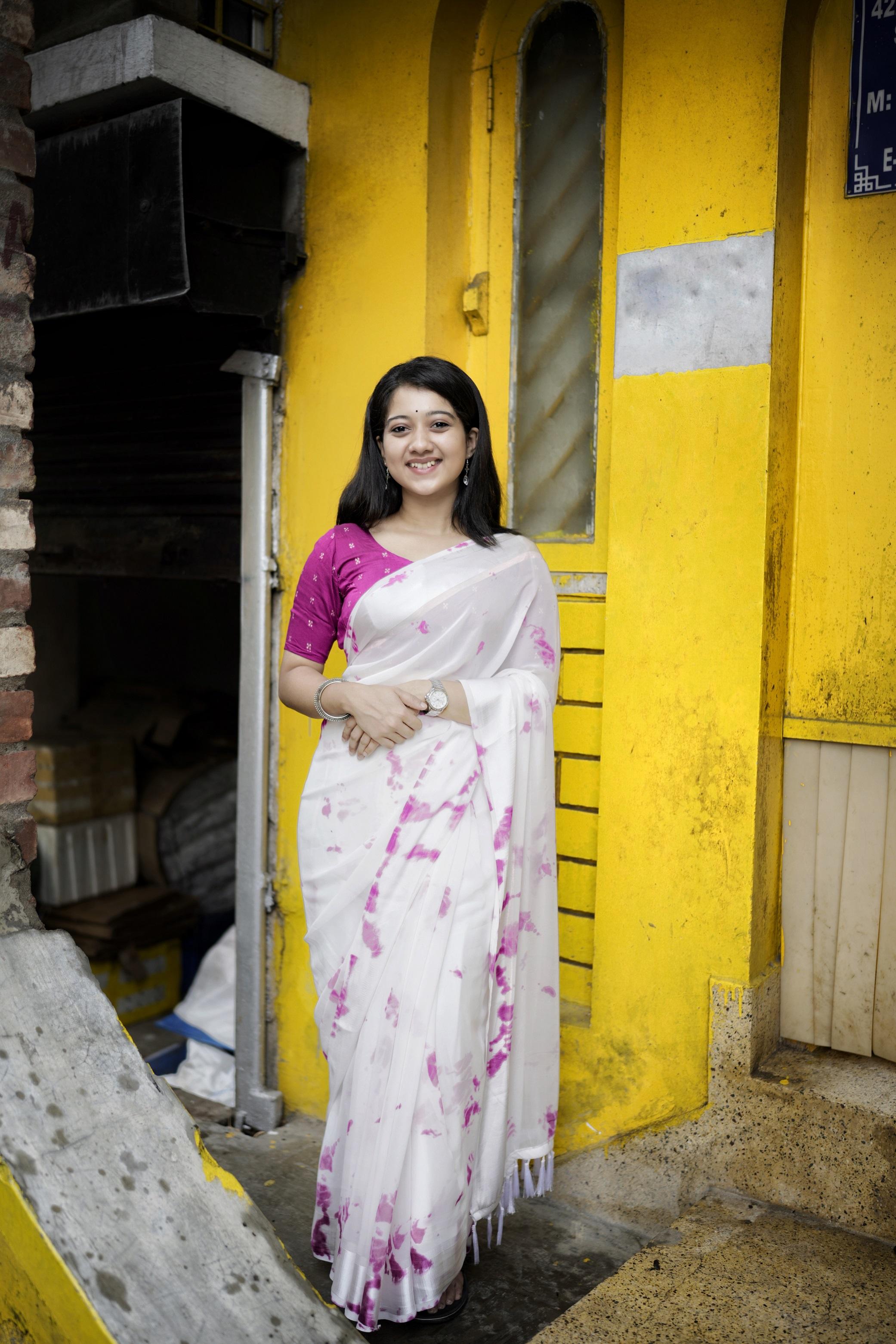 Rani color poly georgette saree with shirobi prints, satin pattu border, and tie-and-dye blouse