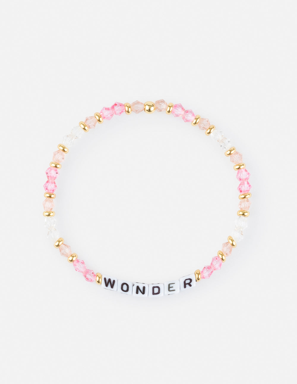 Close up of a stretch beaded bracelet spelling WONDER with pink and clear crystals and gold-tone spacers on a white background.