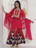 A pink muslin sharara suit set with a flared silhouette.