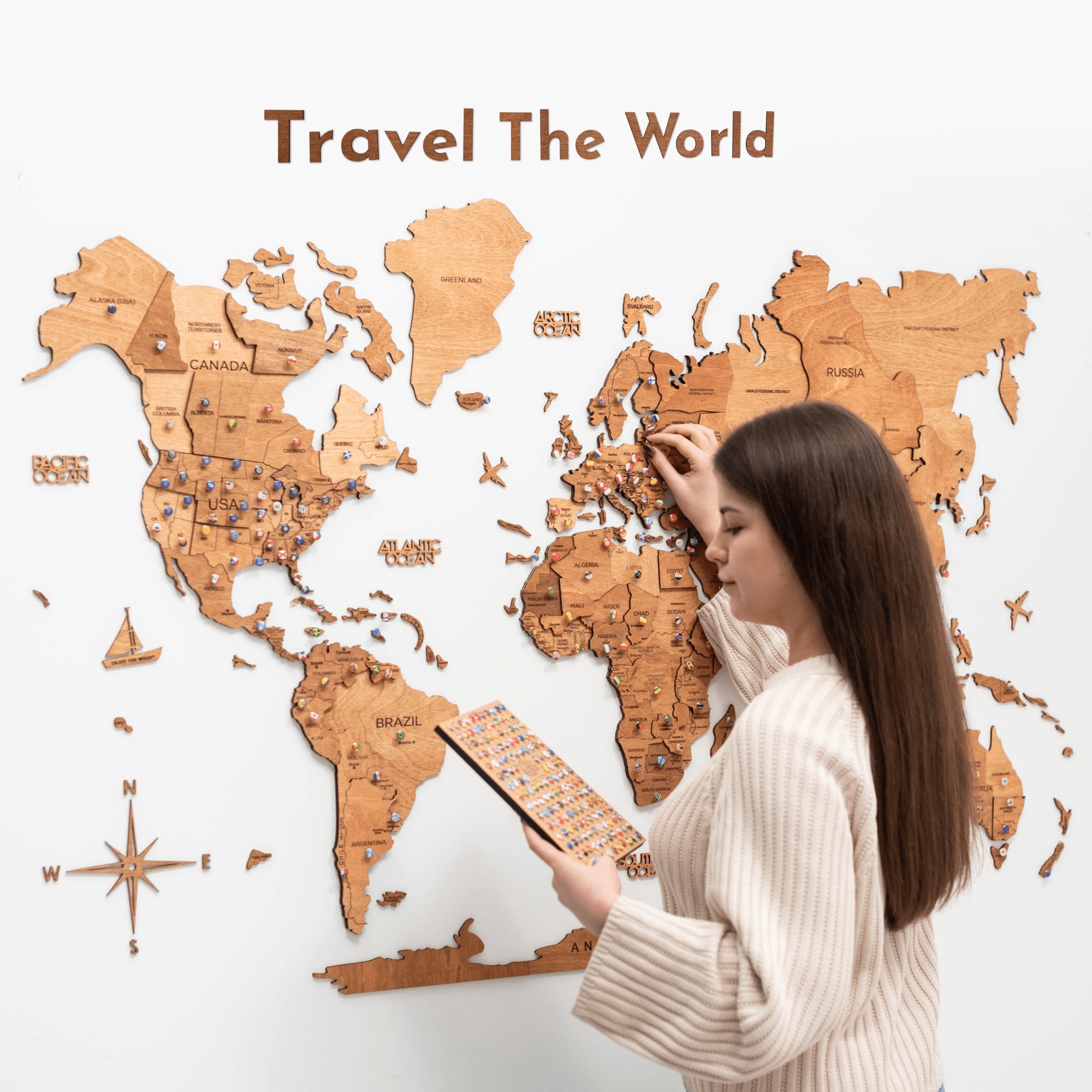 Wooden Map Quote Sign in Oak finish displayed next to a travel map