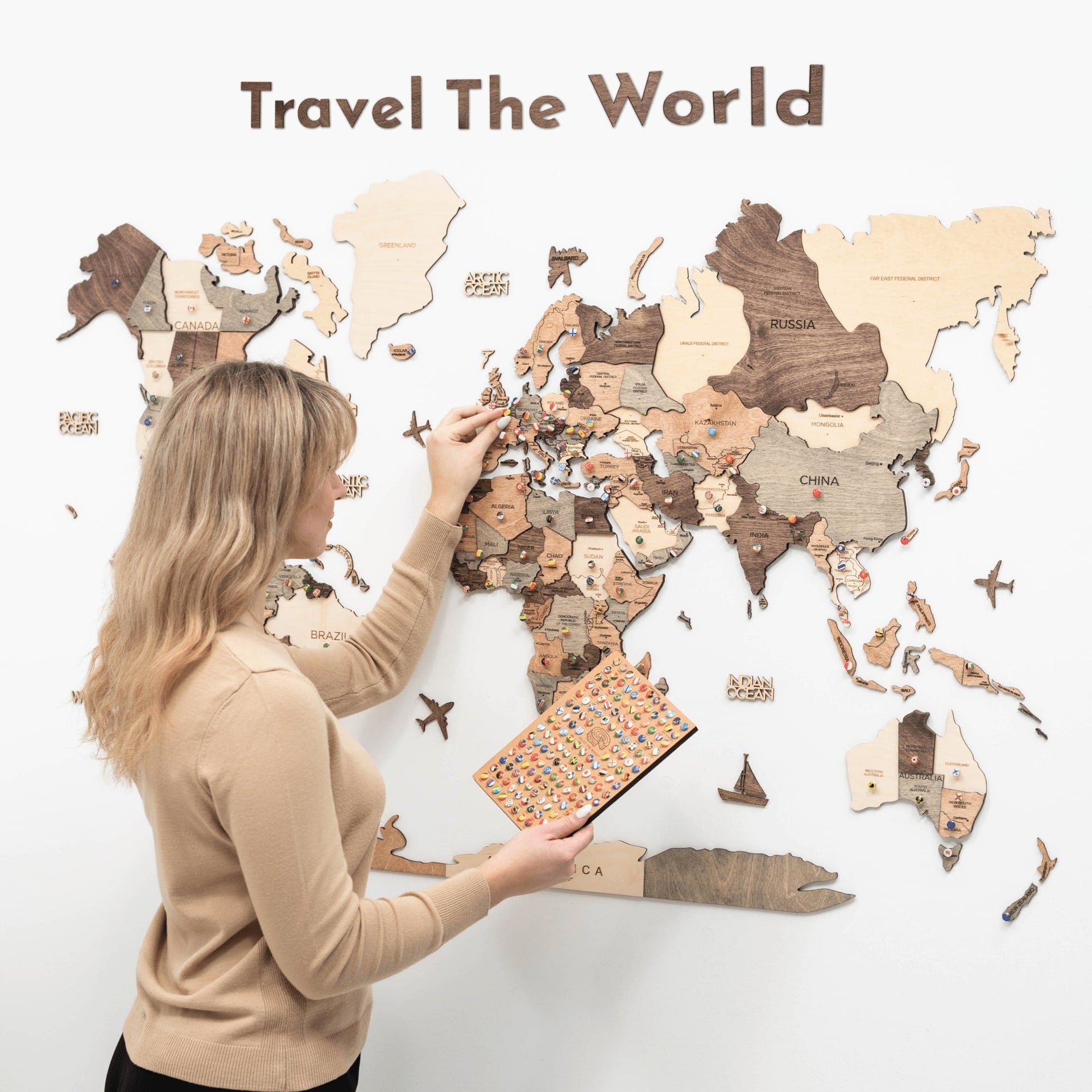 Modern wooden travel quote wall art featuring 'Explore Dream Discover' in a minimalist home office setting