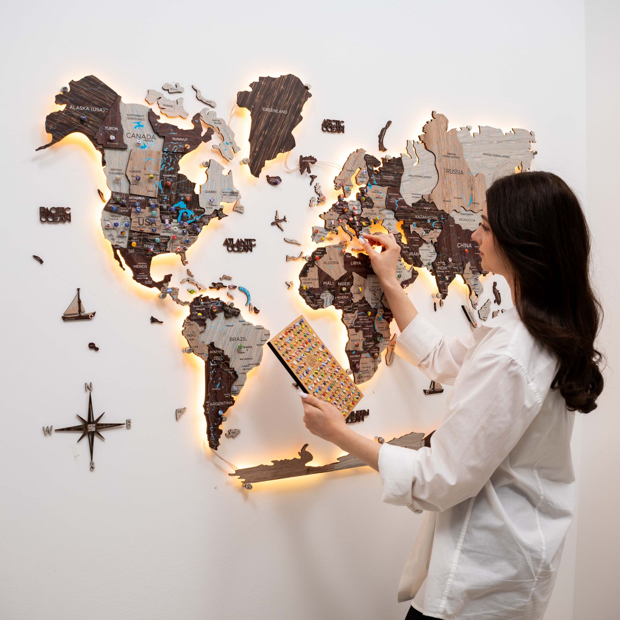 Close-up of the 3D LED Luminous Wooden World Map 3.0 in Cappuccino with glowing backlight
