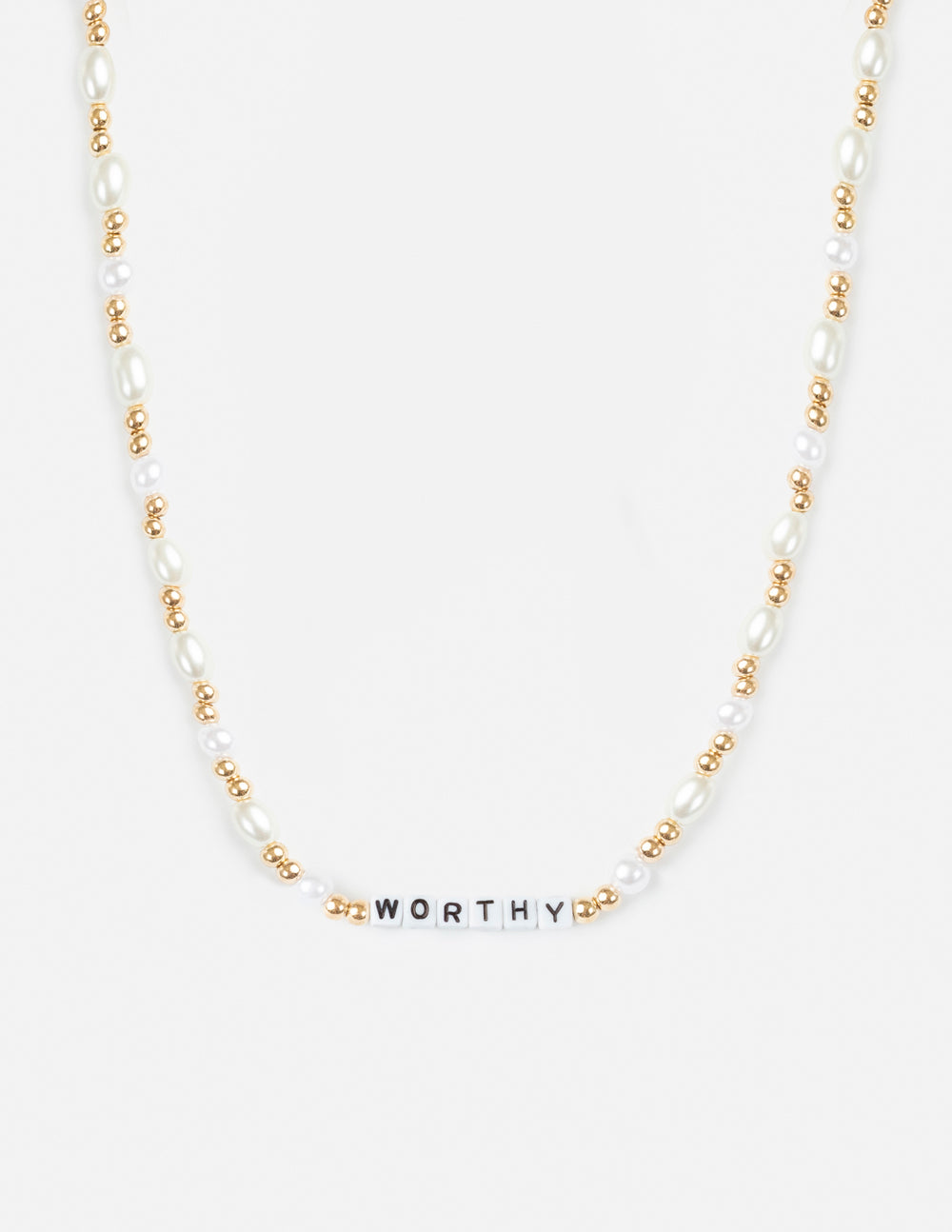 Modern gold Worthy Letter Necklace worn as a casual minimalist accessory.