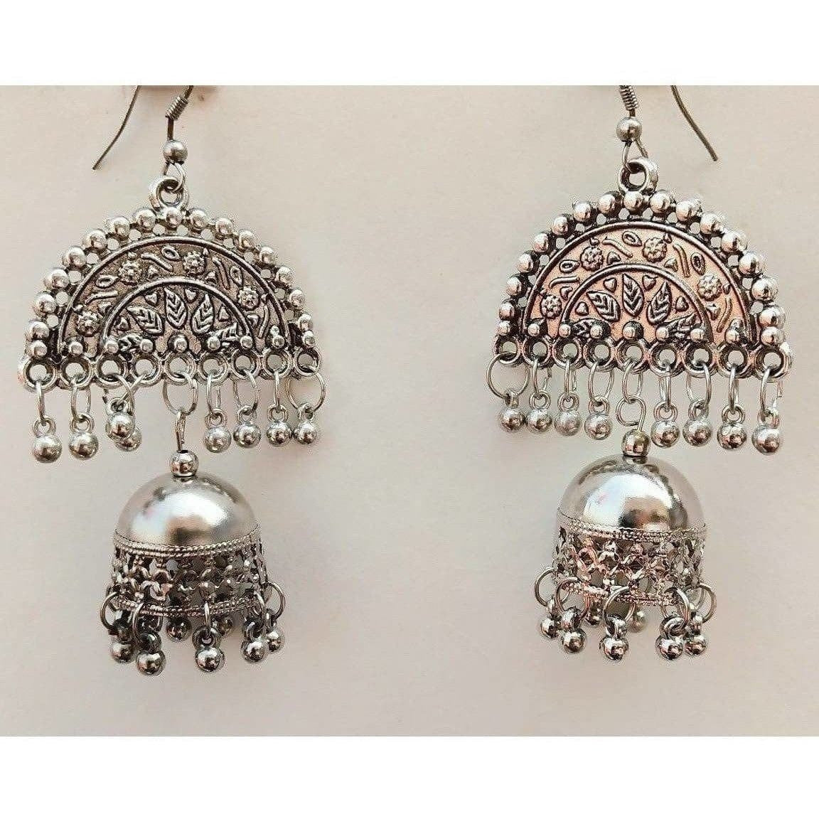 Silver oxidized half moon jhumka earrings with hanging white pearl tassels.