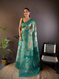 Teal Banarasi silk saree featuring intricate floral motifs and matching unstitched blouse fabric