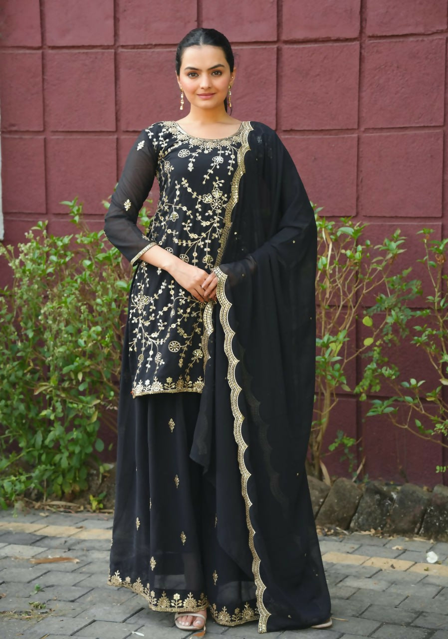 Black georgette embroidered kurti and sharara set styled elegantly.
