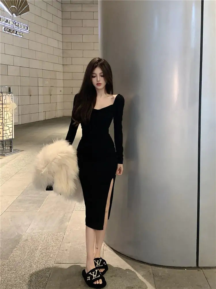 A woman wearing a long sleeve off-shoulder midi dress with a side slit, available in black and dark red.
