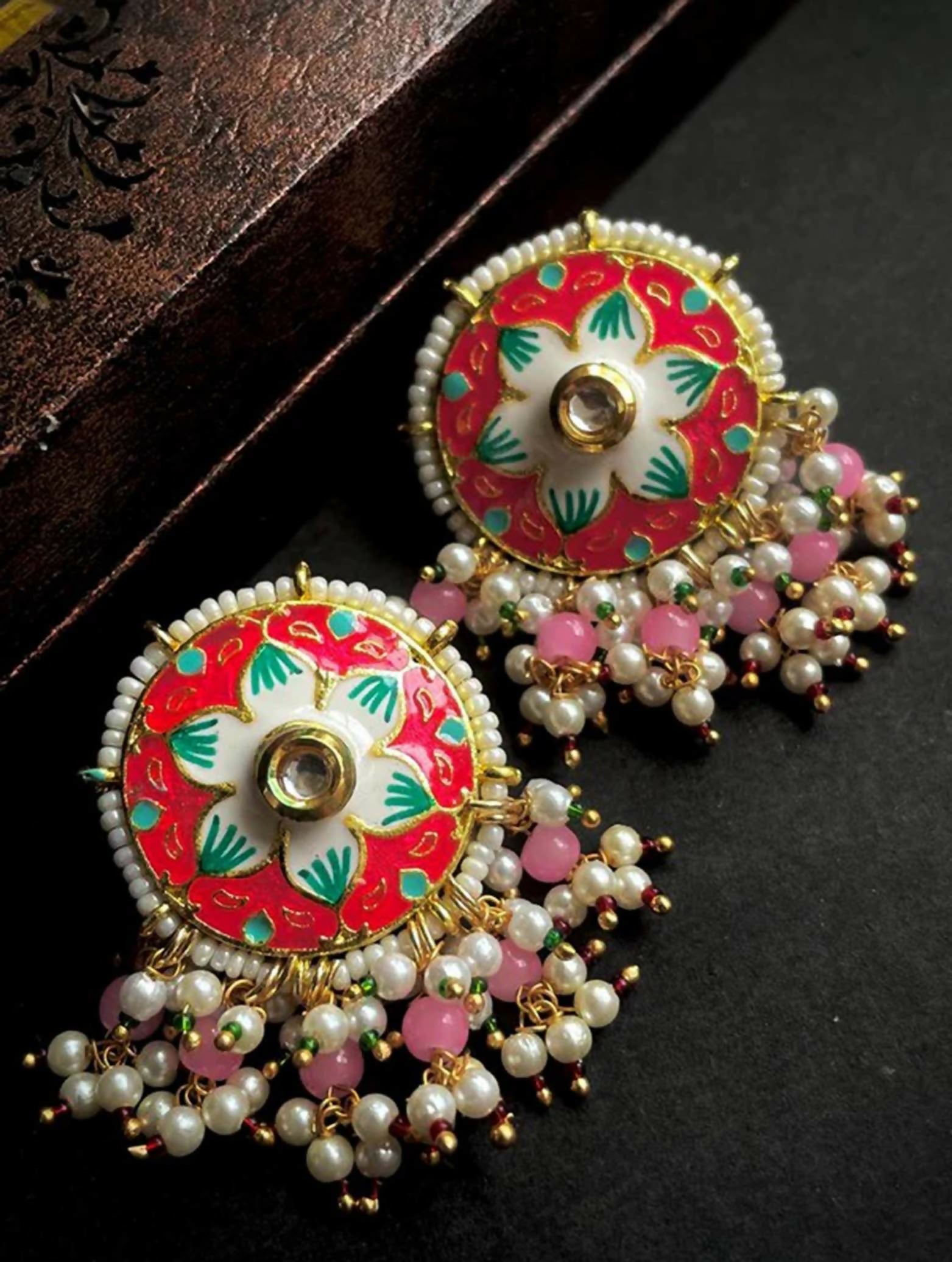 Close-up of Pink Meenakari flower print brass stud earrings for women