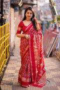 Red cotton crepe saree featuring a zari bentex border and matching unstitched blouse.