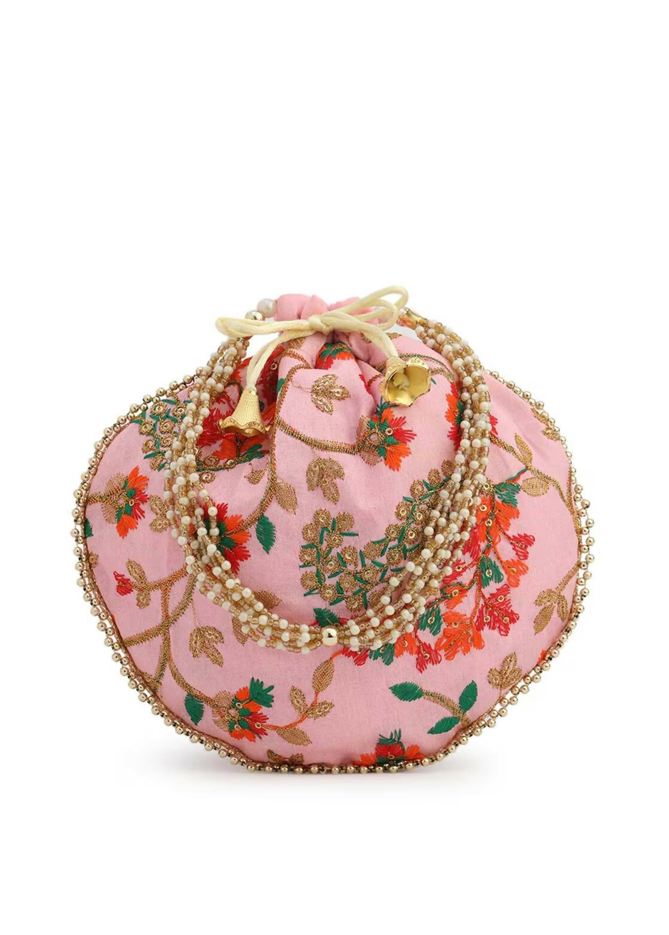 Peach colored potli clutch with intricate embroidery and drawstring closure