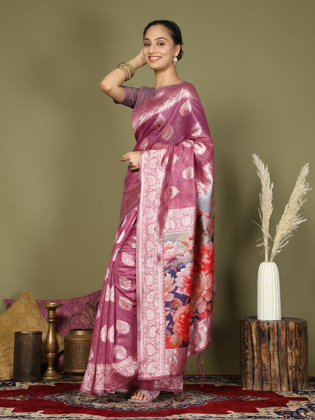 A soft pink linen cotton saree draped elegantly with a matching blouse.