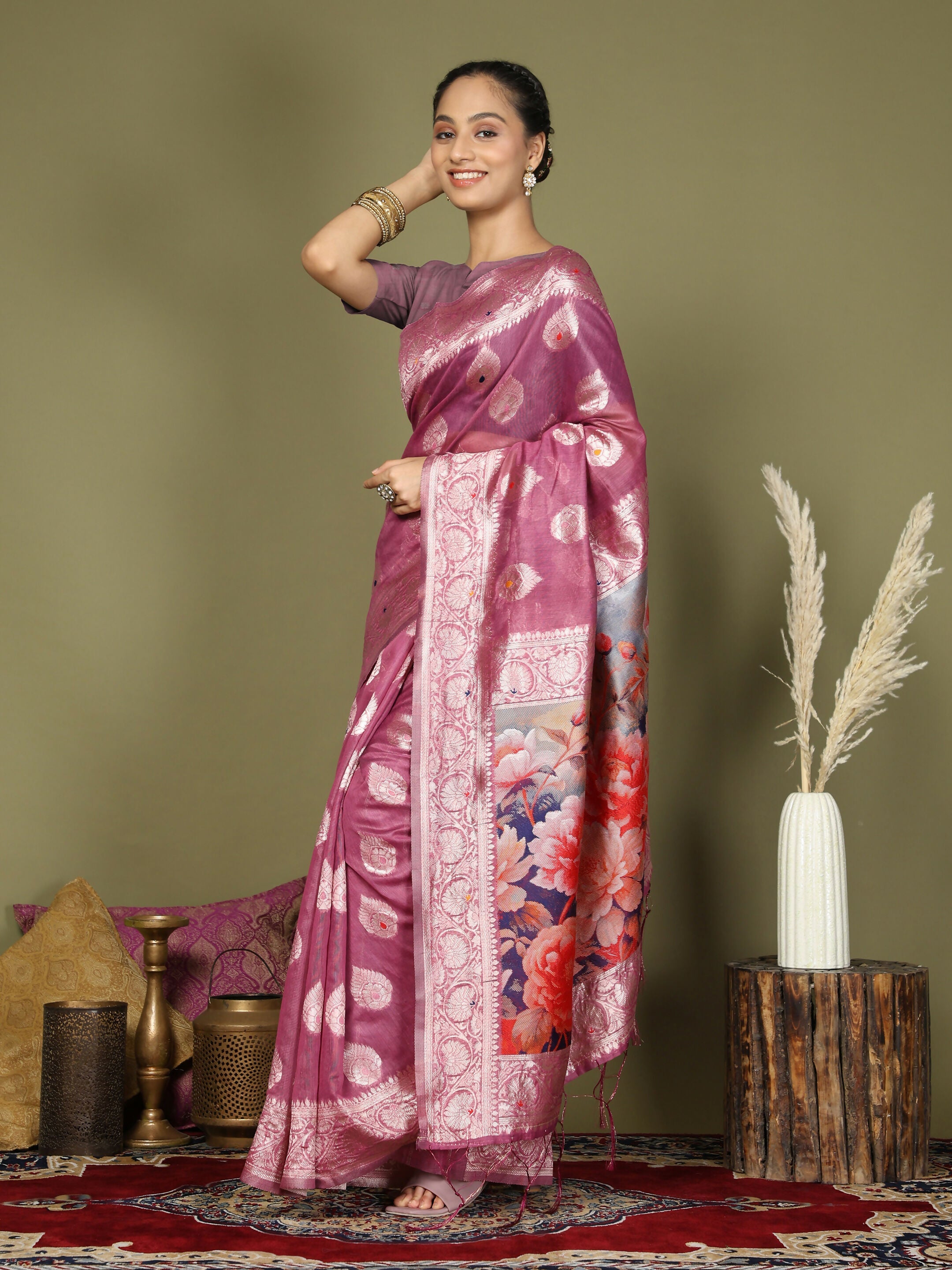 A soft pink linen cotton saree draped elegantly with a matching blouse.