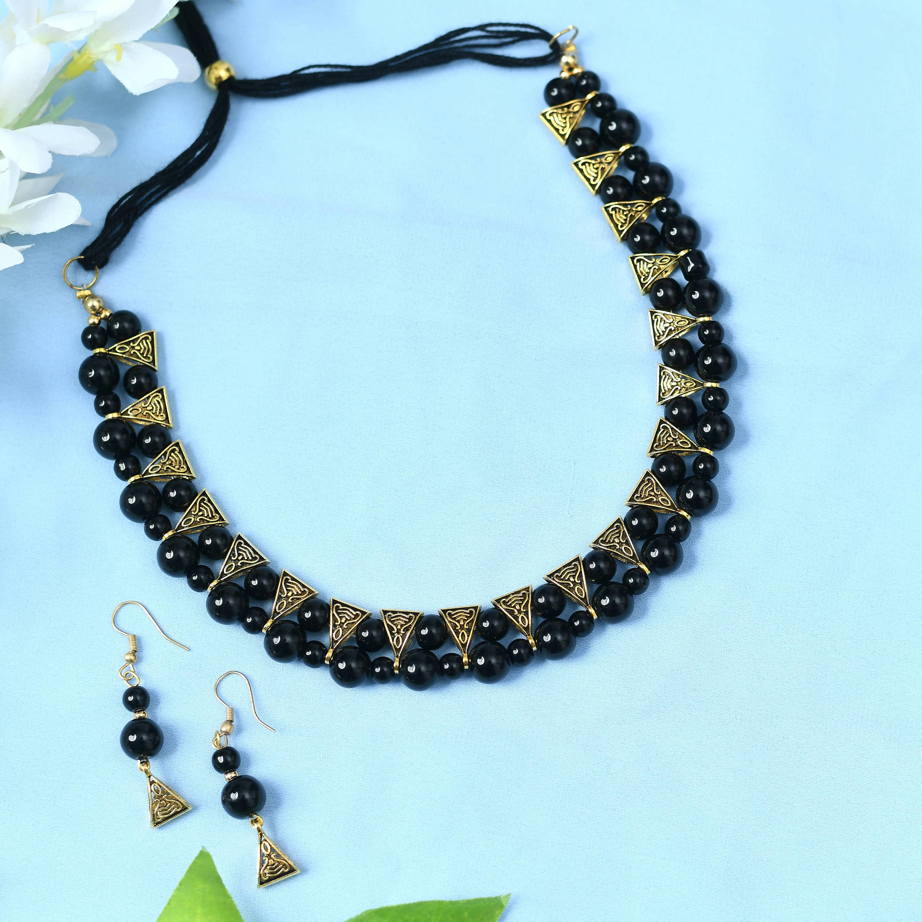 Gold-polished brass choker with pearl and stone work in black and gold