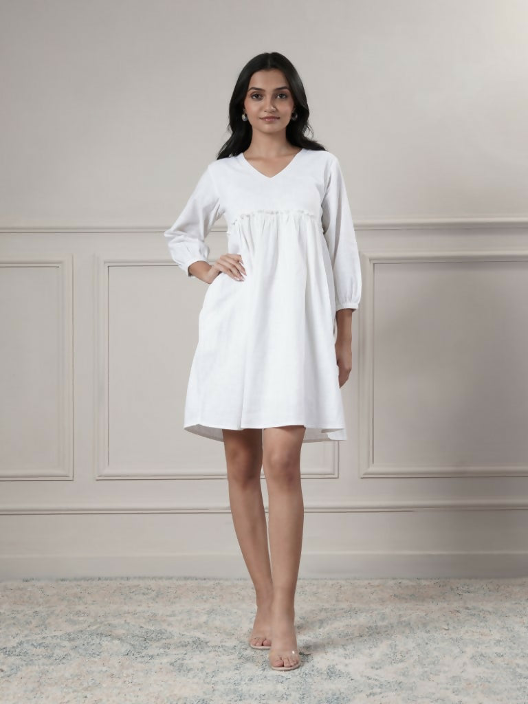 Woman wearing a clean white short dress with a V-neck and 3/4 sleeves