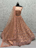 Peach bridal net lehenga choli with dori and zircon diamond work.