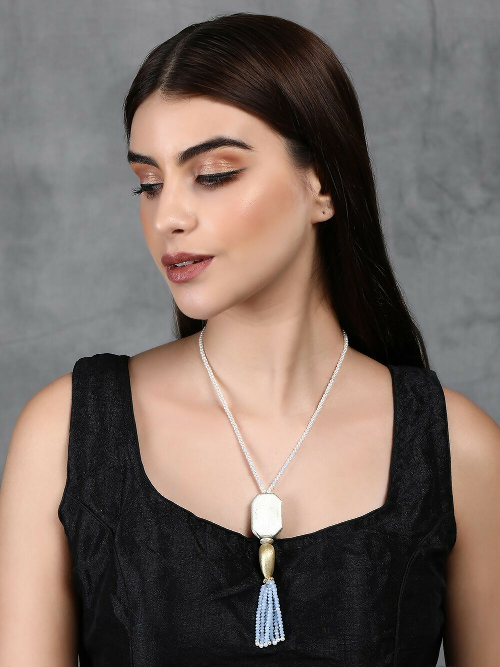 Long silver tone brass statement necklace with intricate patterns and stone detailing