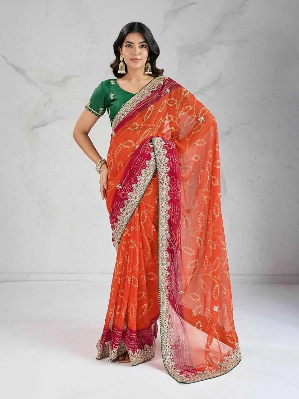 Orange georgette saree with modern digital print and contrasting green blouse