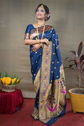 Vibrant blue Paithani silk saree with detailed zari woven accents.