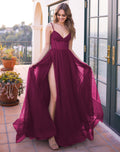 Model wearing the Yasmin A-Line tulle prom gown in mulberry with an illusion bodice and leg slit