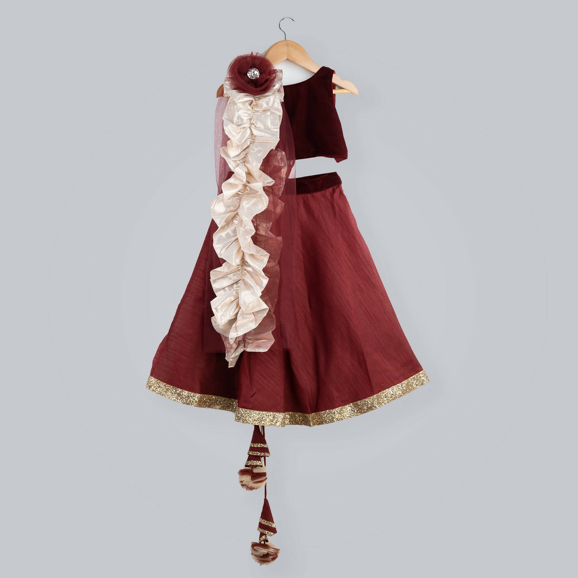Girl's red ghagra choli with maroon velvet sleeveless top and net dupatta with gold frill