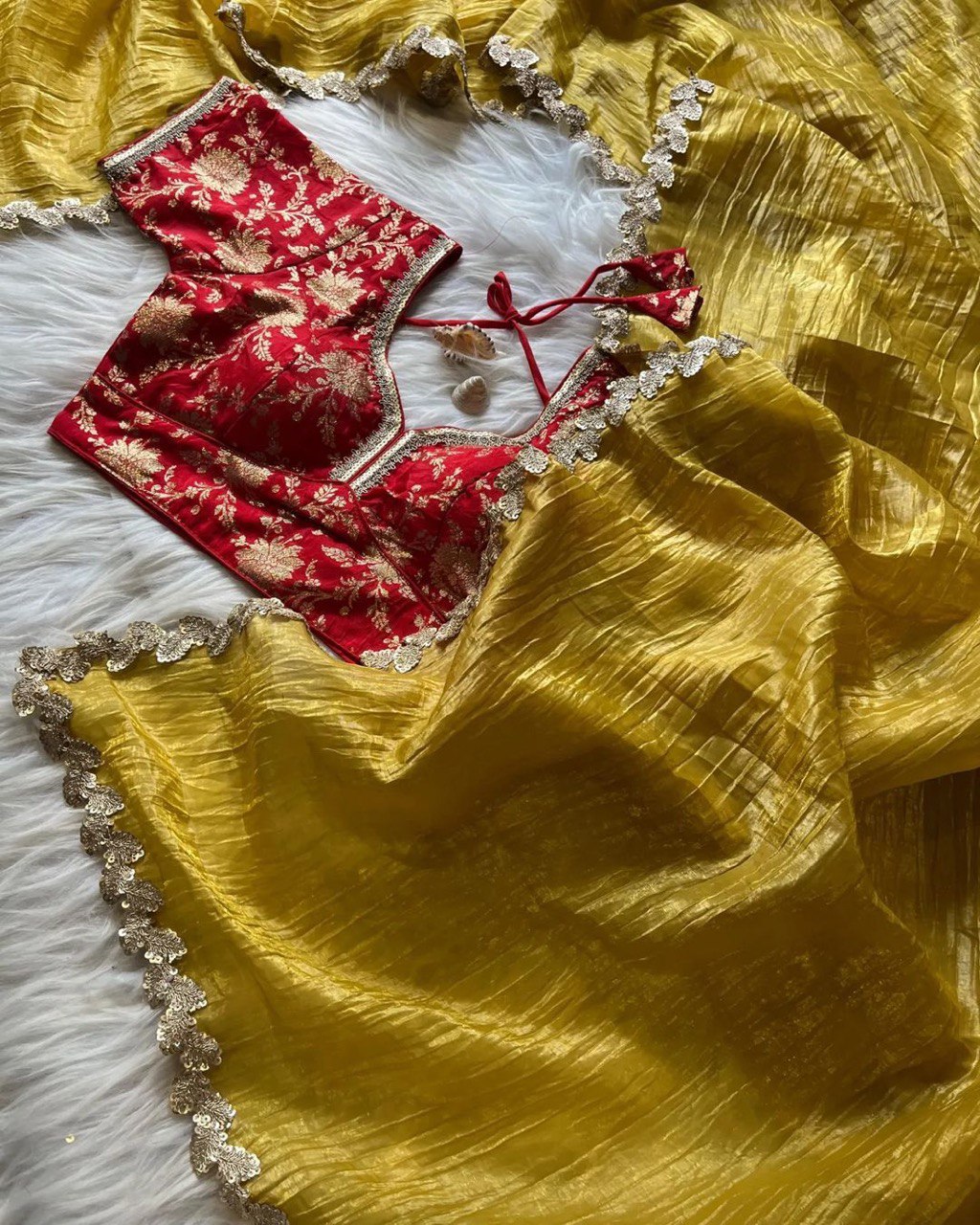 Yellow crushed tissue silk saree featuring fancy lace trim and a stitched Jacquard blouse.