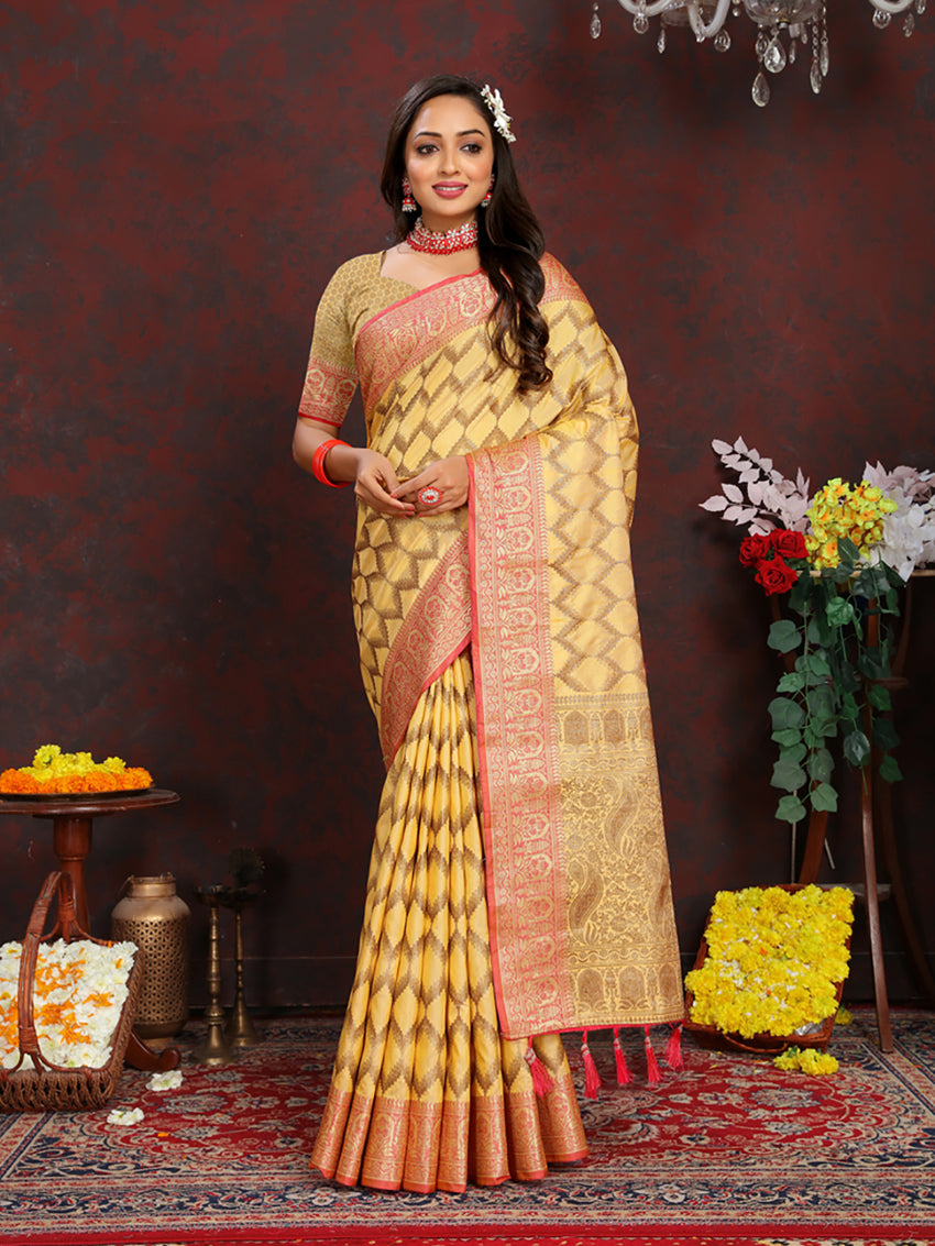Bright yellow soft katan silk saree featuring ornate gold zari weaving on the pallu.