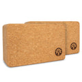 Set of two minimalist natural cork yoga blocks displayed in a bright, modern room
