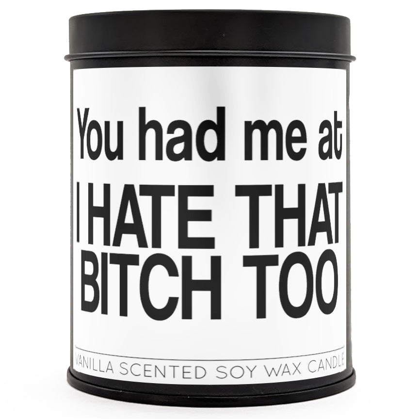 12oz black tin candle featuring witty text, placed next to a wine glass and home decor.