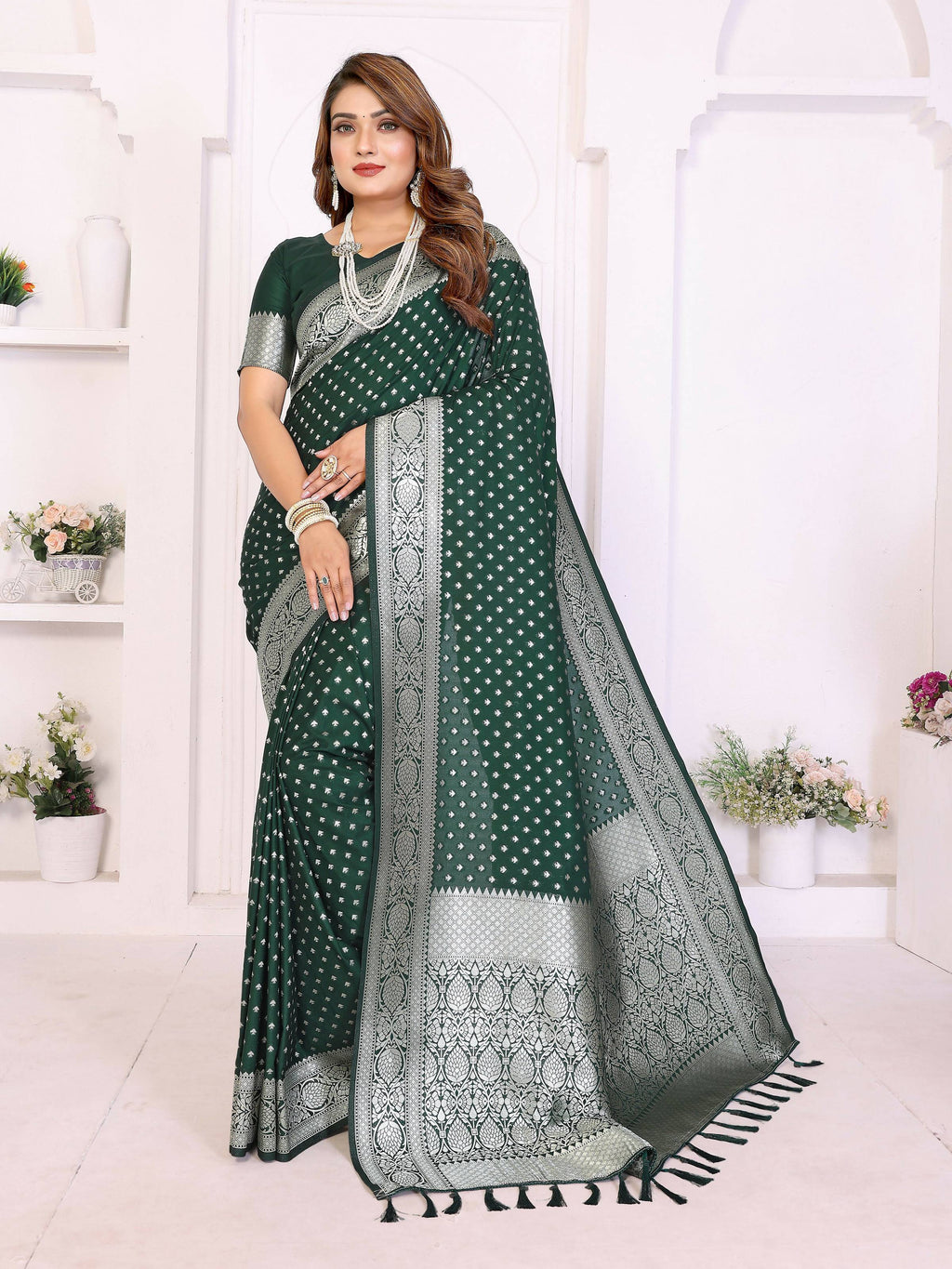 Rich green georgette silk saree with intricate zari weaving patterns.