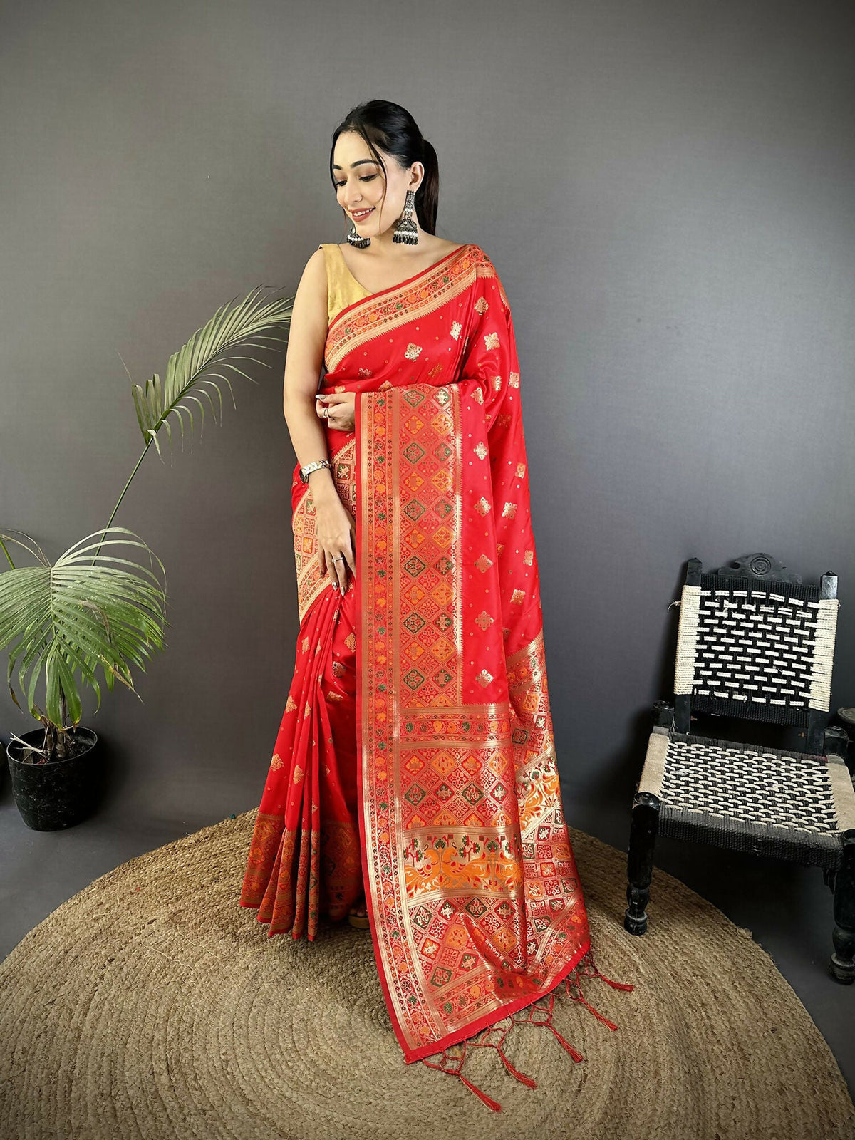 Carmine red soft silk Patola saree featuring intricate geometric patterns