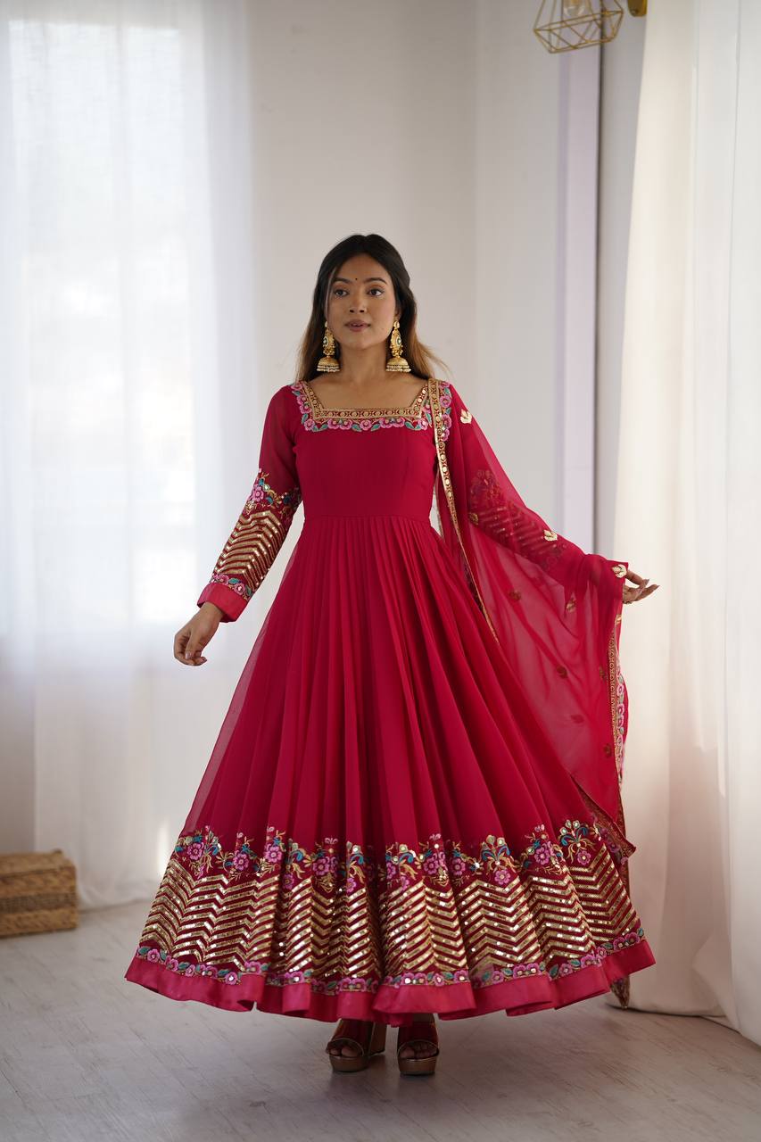 Rani pink georgette Anarkali gown with heavy multi-thread embroidery and sequence detail.