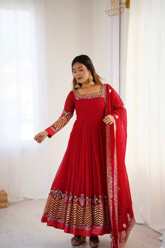Red georgette Anarkali suit with heavy embroidery and gold sequence detail.