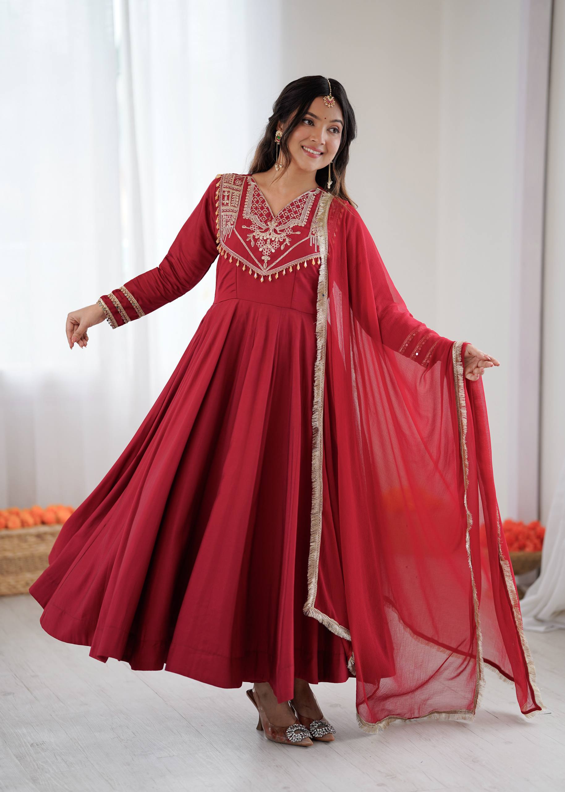 Red Roman silk Anarkali gown with coding work and elegant flare.