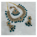 Joban Fashion teal blue stone work necklace set with matching earrings and tikka on a display stand