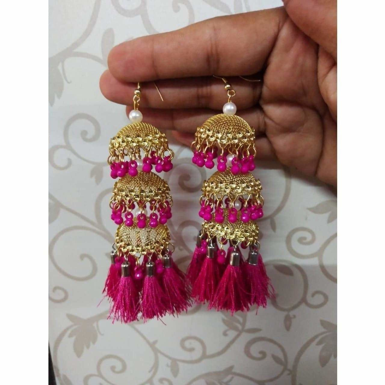 Gold-tone traditional jhumka earrings with pink pearls and silk thread accents