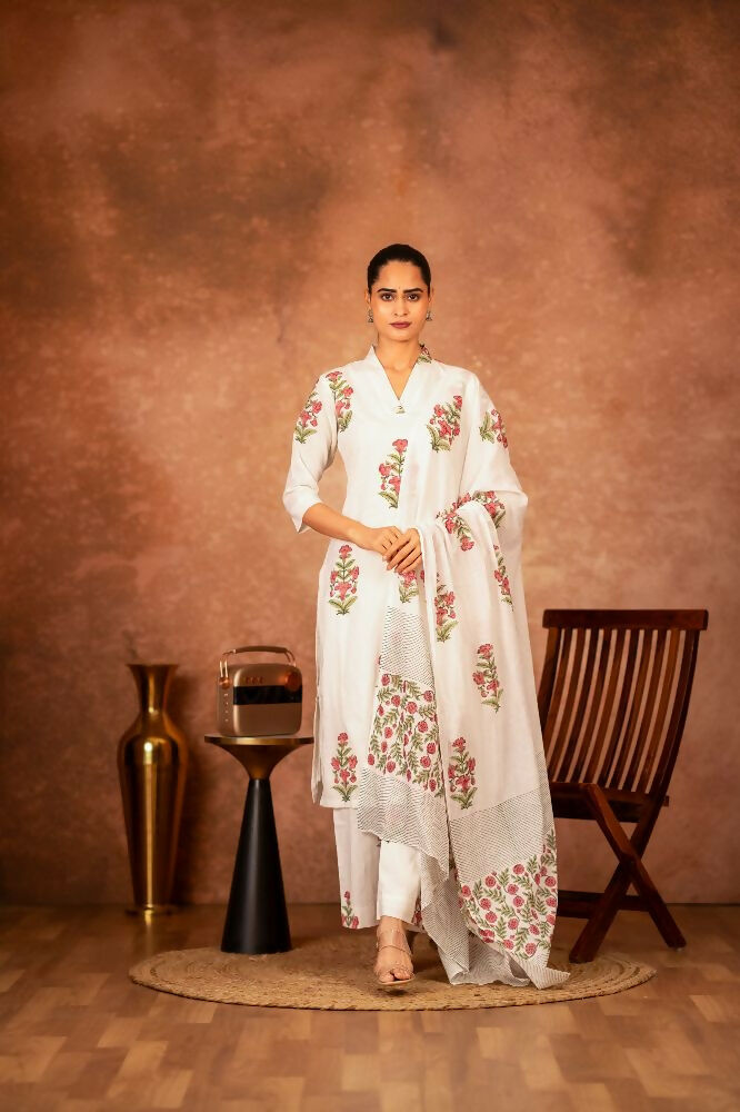 Off-white and pink hand block printed cotton suit set displayed against a neutral background.
