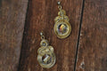 A pair of elegant golden brass earrings featuring white AD stones for women