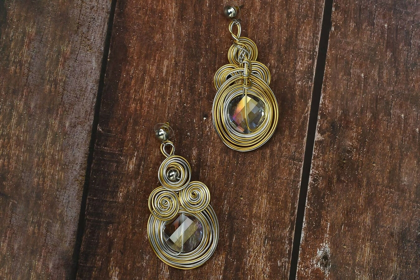 A pair of elegant golden brass earrings featuring white AD stones for women