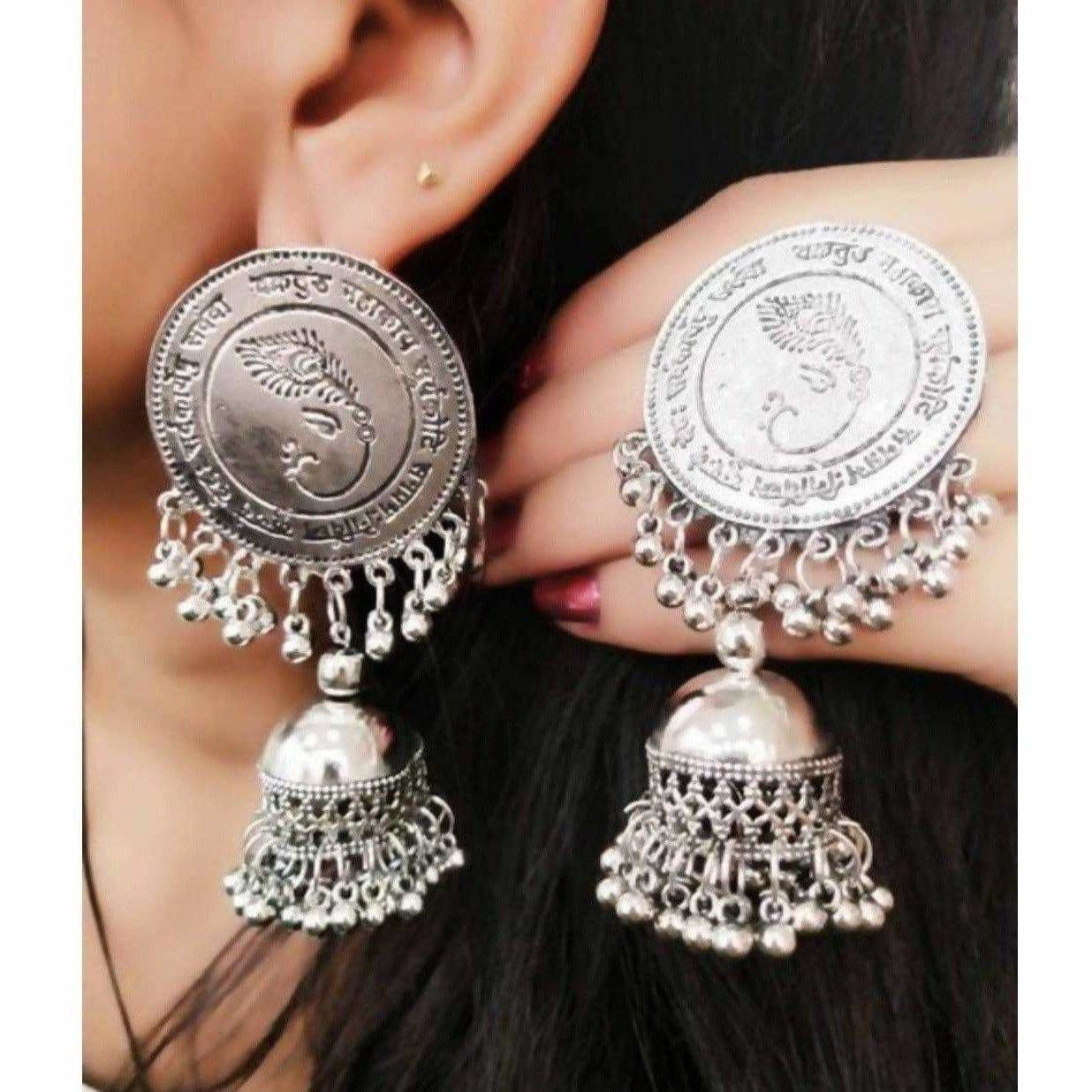 Silver oxidized jhumka earrings featuring a Lord Ganesh symbol