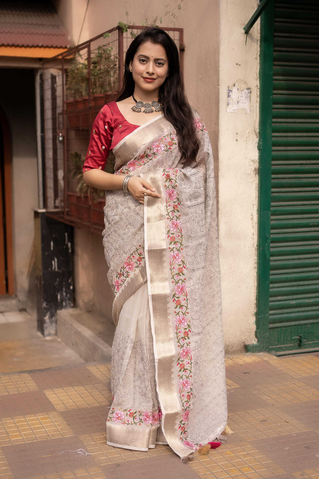 Grey pure linen saree with floral embroidery and zari temple border