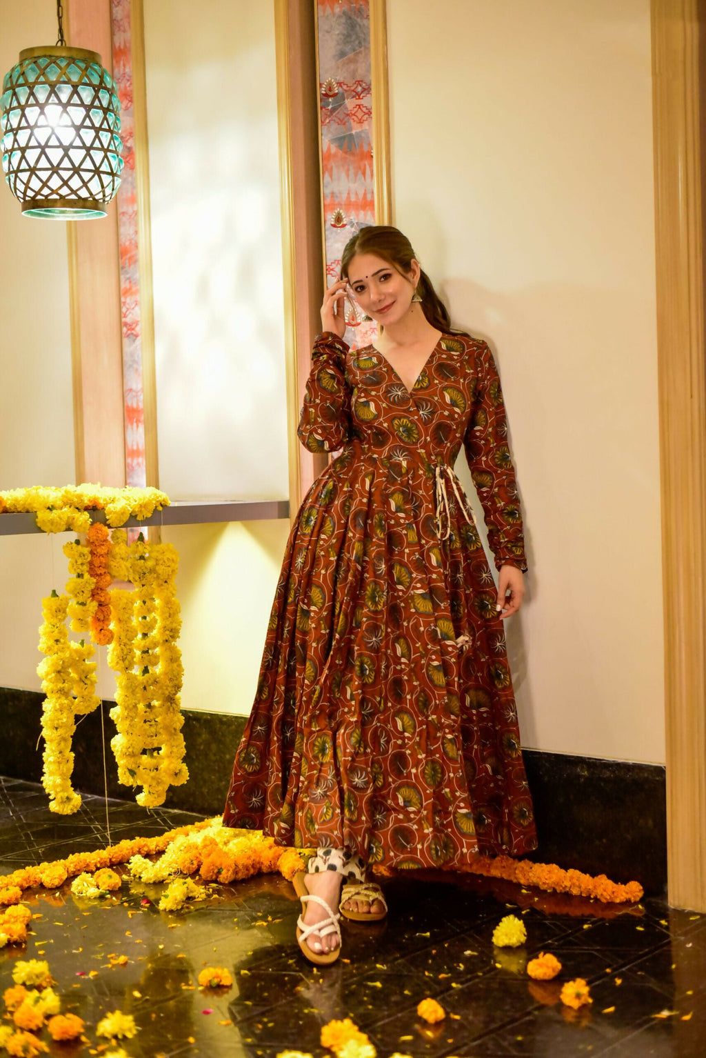 Woman wearing a coffee brown cotton silk A-line kurta set with mustard and green digital botanical prints