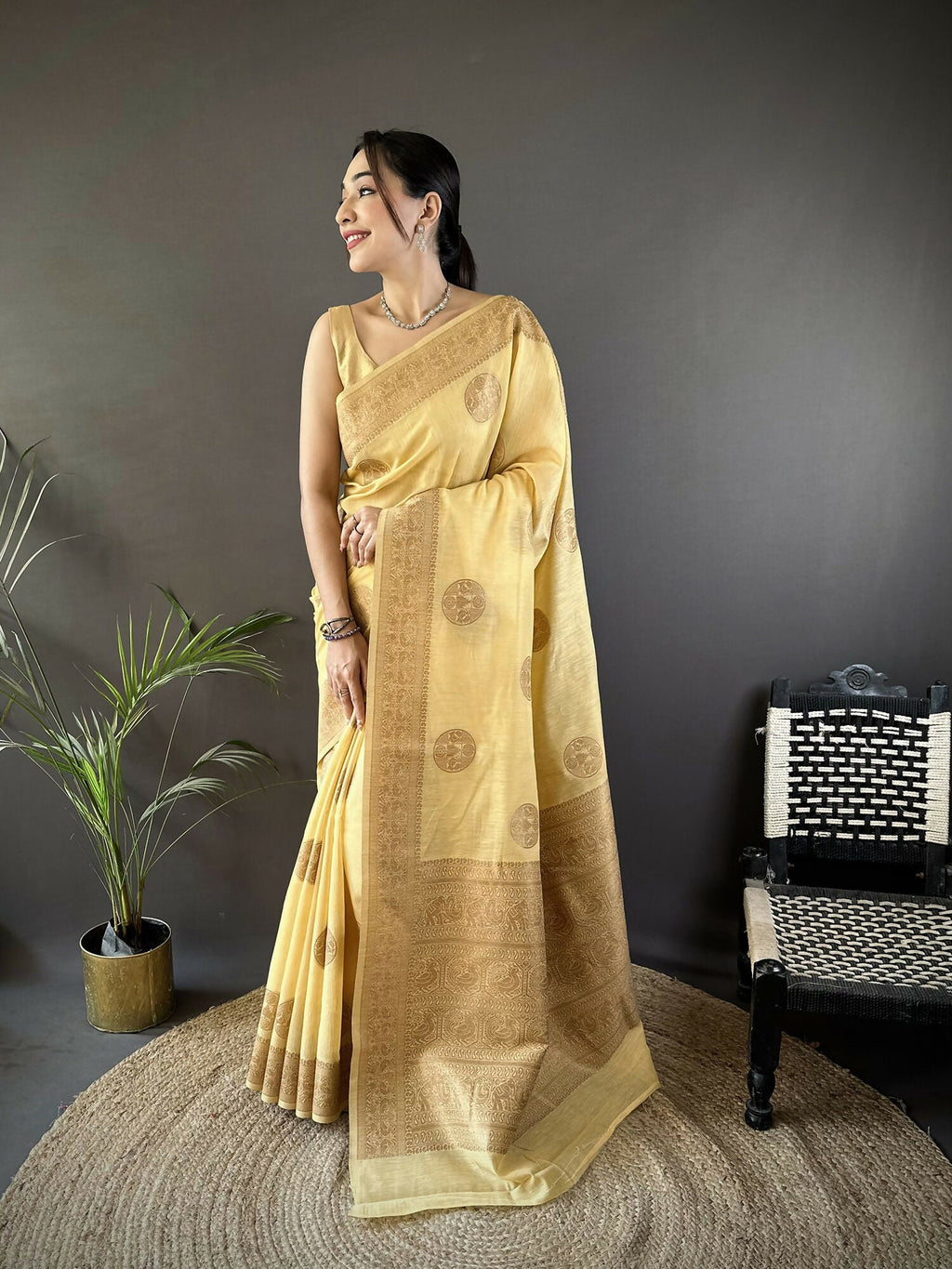Yellow linen silk Banarasi saree with floral and paisley patterns