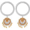 Silver bangle bracelet with orange hanging design charms on a neutral background