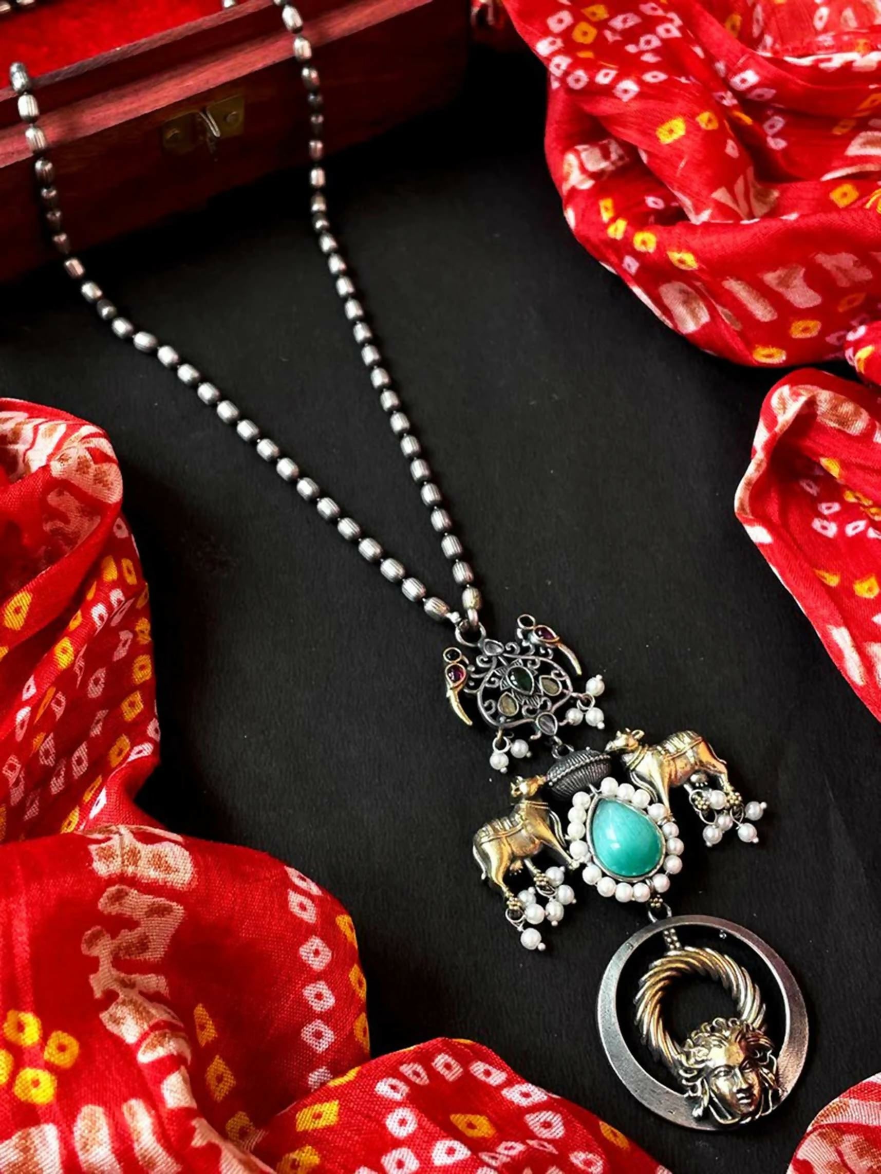Close-up of a sky blue Monalisa stone pendant necklace with dual-tone beads on a brass chain