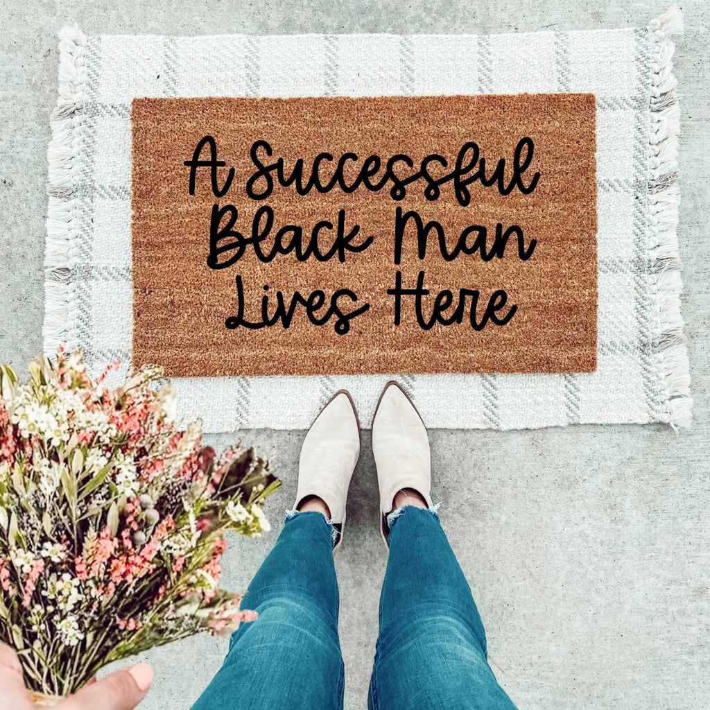 A Successful Black Man Lives Here text on a durable entryway doormat