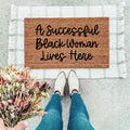 A Successful Black Woman Lives Here text on a stylish entryway doormat
