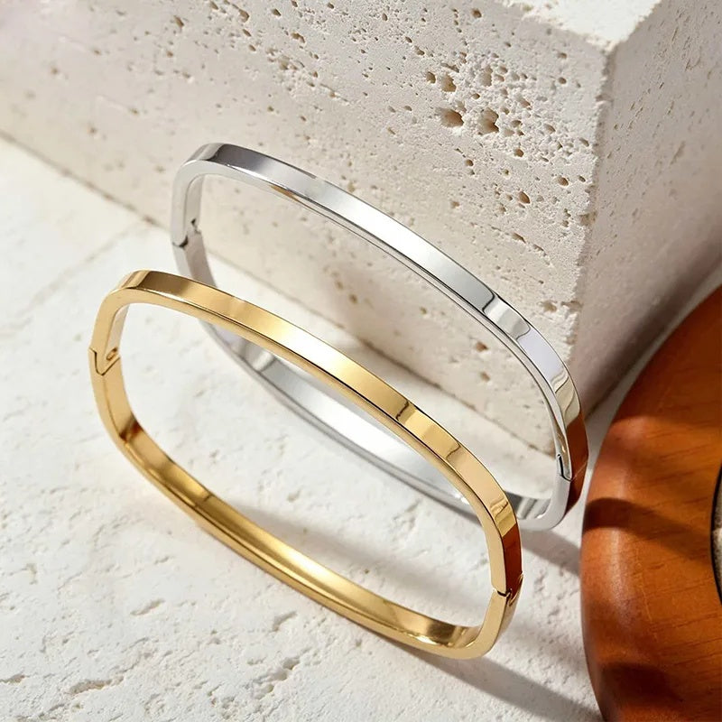 Minimalist stainless steel bracelet with a glossy, light-catching wind-like finish